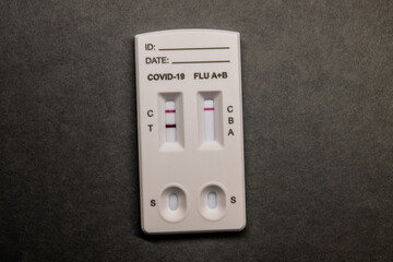 Positive Covid test on grey table.