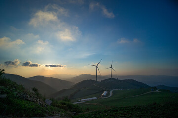 풍력 발전기가 있는 새벽 산 위 정상 풍경