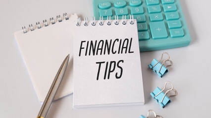 Financial Tips Text on White Notepad Paper on Light Background Near Calculator, Pan, Table.