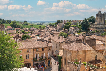 Scenic view of the medieval town of St Emilion, Bell tower and vineyards in Bordeaux region, France.