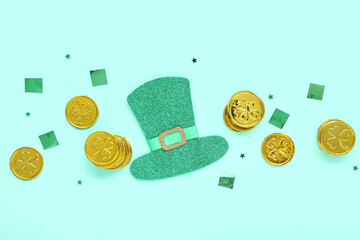 Golden coins with sequins and paper leprechaun hat on blue background. St. Patrick's Day celebration
