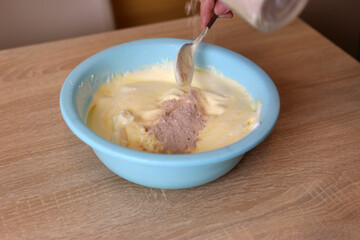 Preparation of pastry dough with the addition of cocoa. Making a sweet cake.
