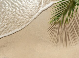 Fototapeta na wymiar Idyllic empty sand beach with water wave and palm leaf shadow from above, beautiful sunny summer vacation background with copy space for text or product presentation, flat lay