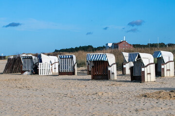 Small coastal huts for rest and shelter on sandy North Sea beach, Cuxhaven, Germany