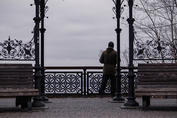 Kyiv, Ukraine - January 2, 2024: a man stands and looks from the observation deck at the city from...