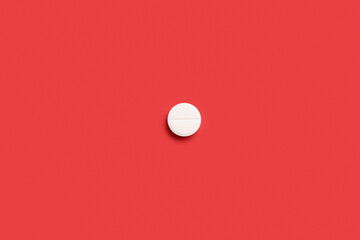 Medical pill on red background