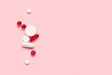 Different medical pills on pink background