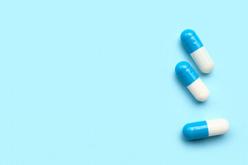 Medical capsules on blue background