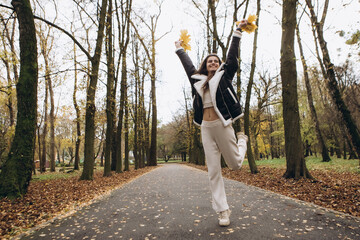 Attractive pretty woman walking outdoor, portrait of young lady in warm sunny autumn park season,...