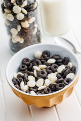 Sweet breakfast cereals in bowl on white table.