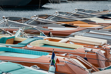 Few luxury retro motor boats in row at the famous motorboat exhibition in the principality of...
