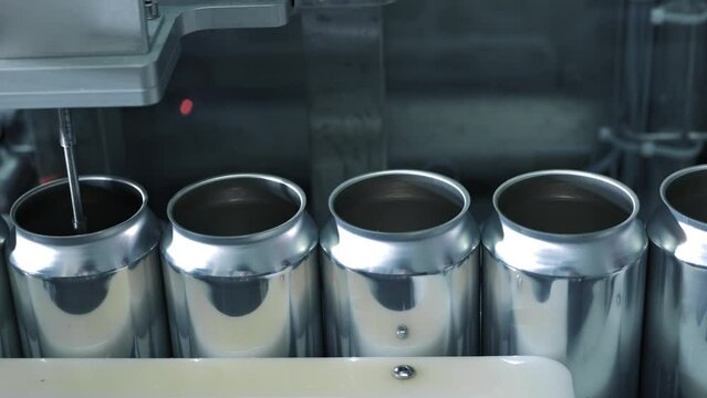 Empty new aluminum cans for drink process in factory line on conveyor belt machine at beverage manufacturing. food and beverage industrial business concept. High quality 4k footage