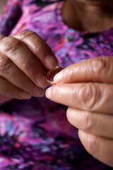 elderly woman puts wedding ring on her finger, romantic, melancholy concept