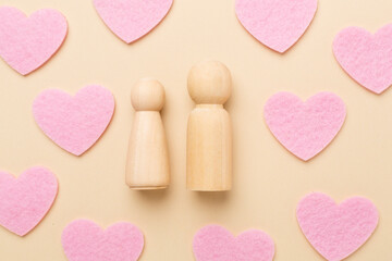 Wooden couple in love on color background, top view. Creative valentine's day composition