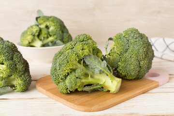 Composition with fresh tasty broccoli on wooden table