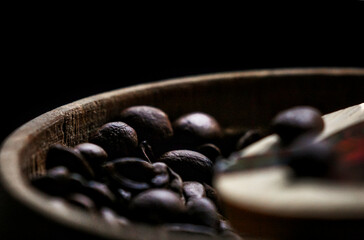 Coffee beans in a wooden bowl.