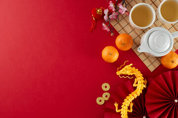 Engaging in the chinese New Year tea ceremony tradition. Top view photo of teapot, cups of tea,...