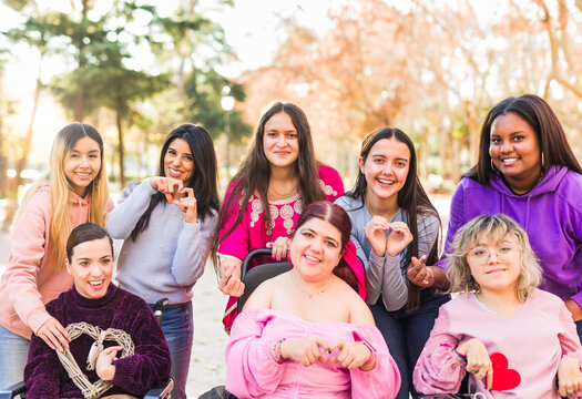 InspireInclusion international womens day. Multiethnic group do heart love hand gesture. Disability
