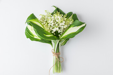 Lily of the valley flowers bouquet on white background. Womens day, Valentines day card. Top view. Flat lay