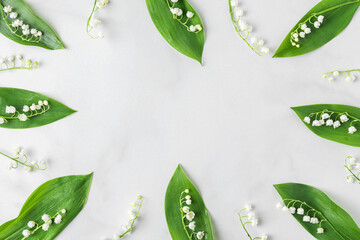 Flower composition. Frame made of lily of the valley flowers on white background. Flat lay. Top...