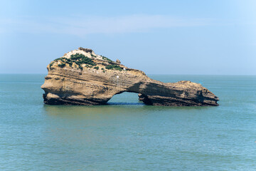 Stone rock archway in Atlantic ocean off the French coast in Biarritz