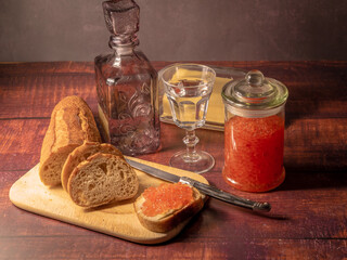 Antique-style still life with vodka and red caviar. - 701962609