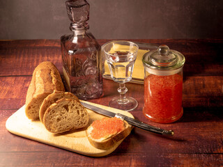 Antique-style still life with vodka and red caviar. - 701962615