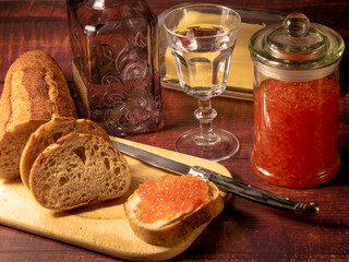 Antique-style still life with vodka and red caviar. - 701962632