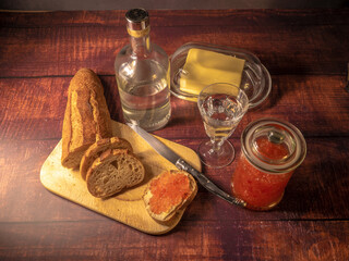 Antique-style still life with vodka and red caviar. - 701962660