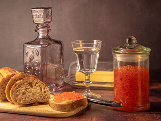 Antique-style still life with vodka and red caviar. - 701962691