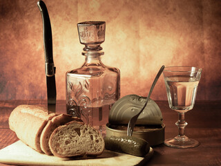 Antique-style still life with alcohol, vodka, canned fish, bread and cucumber. - 701962811