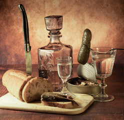 Antique-style still life with alcohol, vodka, canned fish, bread and cucumber. - 701962839