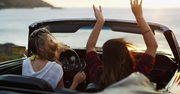 Nature, travel and girl friends on road trip for holiday, vacation or weekend together. Adventure, freedom and young women driving a car in wind for transportation, tourism or sightseeing by coast.