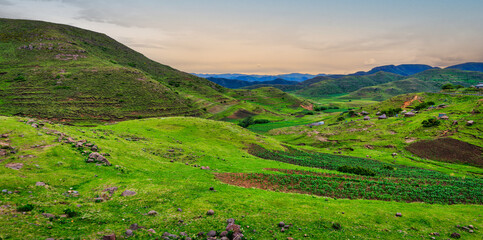 Panorama shot of rural village surrounded by rolling hills and mountains in the Lesotho highlands