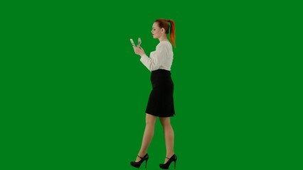 Portrait of attractive office girl on chroma key green screen. Woman in skirt and blouse walking...