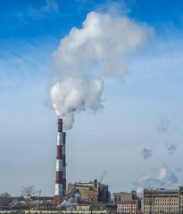 The chimney emits exhaust gases into the blue sky. The concept of air pollution and the environment.	