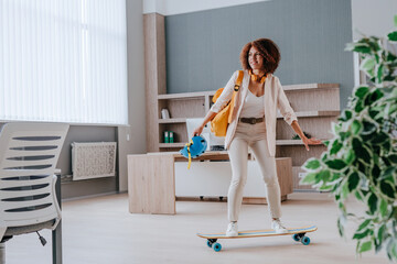 Elegant businesswoman in casual clothes riding on skateboard