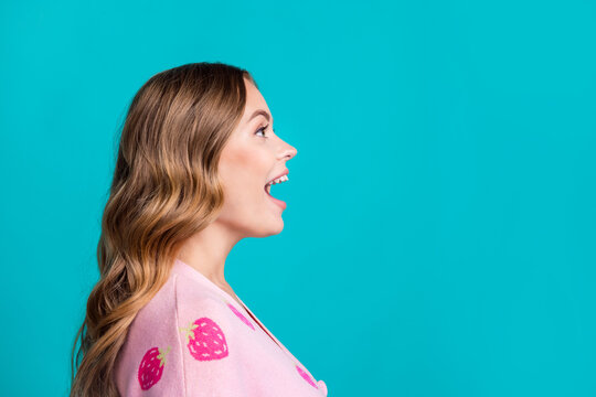 Side profile photo of amazed brown hair curls model woman in pink jumper open mouth amazed look novelty isolated on blue color background
