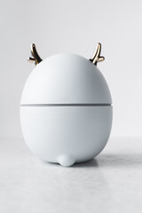 white deer humidifier with gold antlers on a white background, elk humidifier on a marble counter