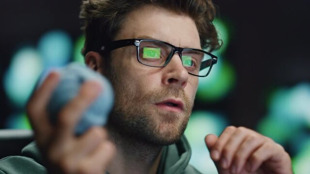 Serious computer scientist working in data center closeup. IT man holding ball