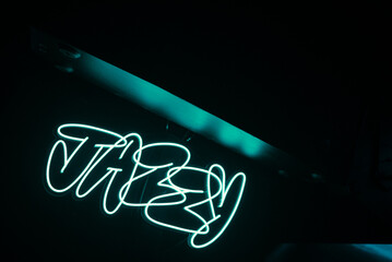 Neón azul con el texto Jazzy en una discoteca