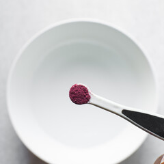 Beet powder in a measuring spoon, freeze dried beet powder in a spoon