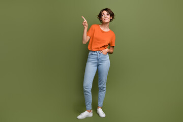 Full size photo of adorable woman wear stylish t-shirt in glasses directing look at logo empty...
