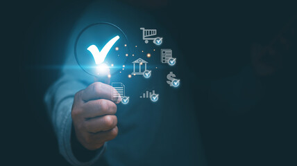 Audit Document concept, Businessman holding a magnifying glass and check mark icon for show audit document, Business document evaluation, Information report analysis and consulting.
