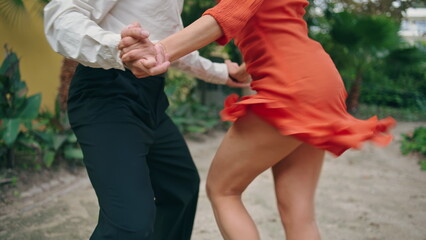 Hot street dancers performing latin american choreography in city park close up
