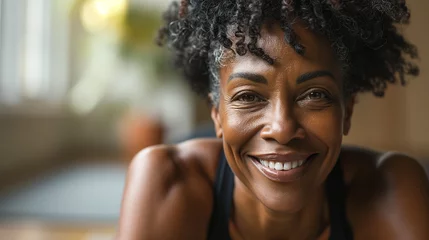 Papier Peint photo autocollant Fitness Professional Portrait of an active black African American mature woman smiling and doing fitness pilates at her home gym