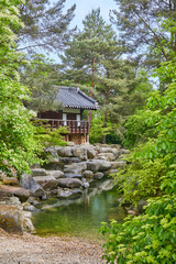 Idyllic little Japanese temple above a stream, in a park near Marzahn, Berlin, Germany. 