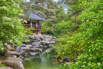 Idyllic little Japanese temple above a stream, in a park near Marzahn, Berlin, Germany. 