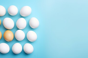 Easter themed photo of white eggs yolks and blue backdrop from above