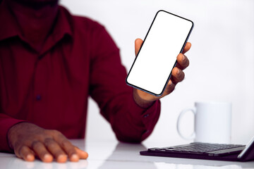 Black man holding and showing smartphone with blank screen isolated over white background. 3D...